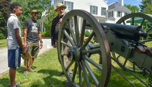 Visitors gather around a cannon.