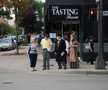 Reenactors guiding tour-goers past The Tasting Room restaurant in downtown Frederick.