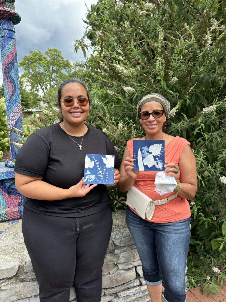 Photo of two artists with their cyanotypes