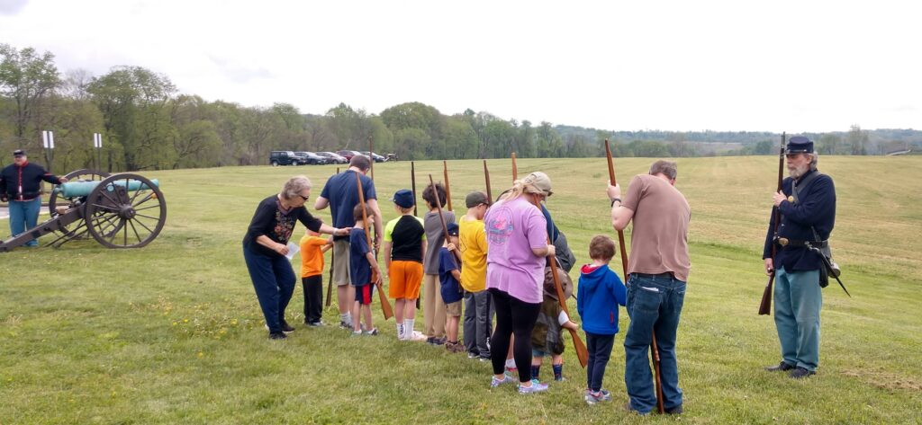 Photo of living history volunteers with visitors